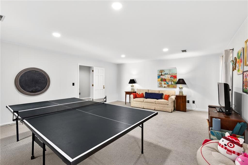 3642 Mayfair Road Northeast Atlanta, GA 30305 - Photo 35 of 40 a living room with a table chairs and a flat screen tv