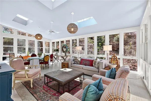 a living room with furniture a rug and a large window