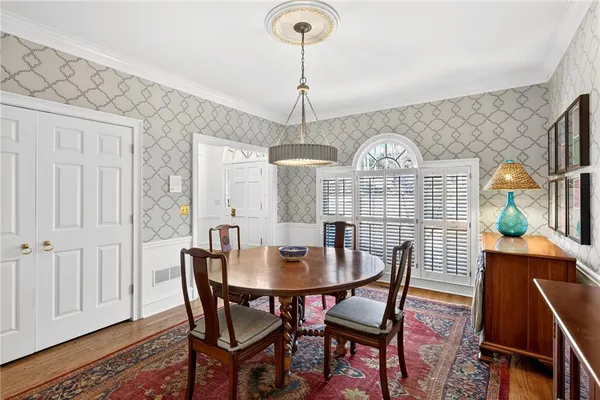 a view of a dining room with furniture window and wooden floor
