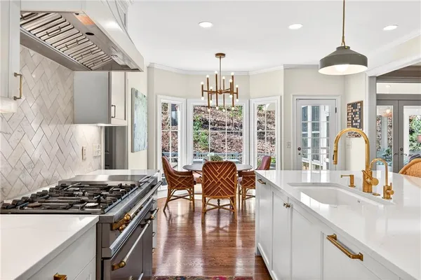 a kitchen with stainless steel appliances granite countertop a stove and a sink