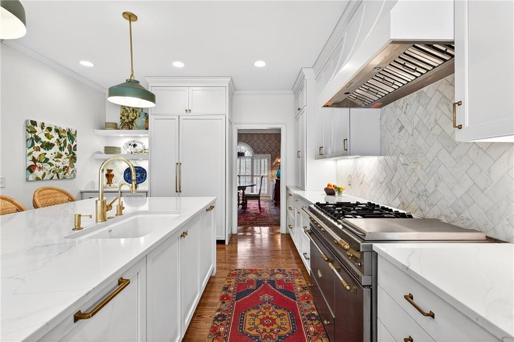 3642 Mayfair Road Northeast Atlanta, GA 30305 - Photo 10 of 40 a kitchen with kitchen island a stove a sink and a refrigerator