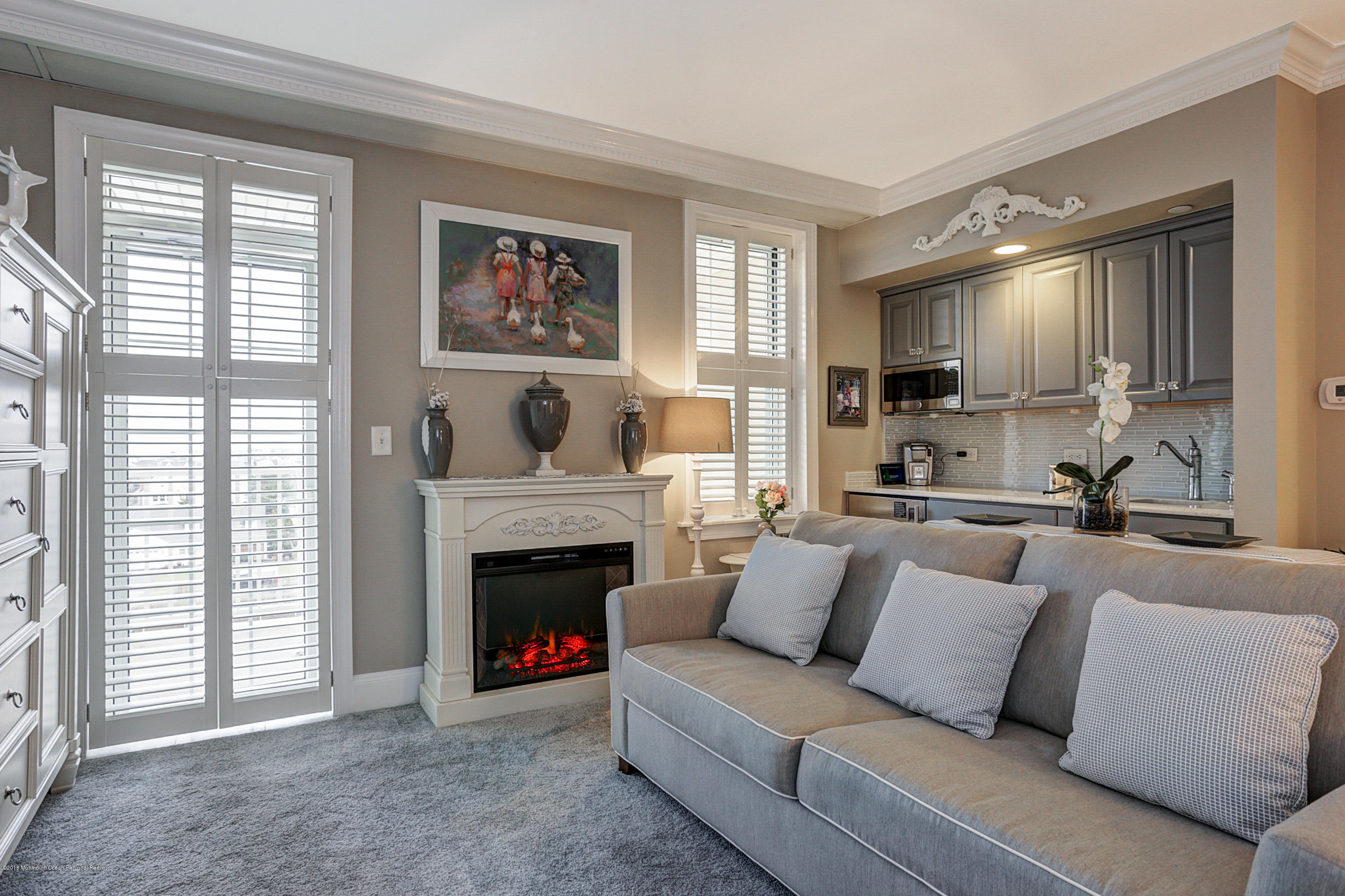 700 Ocean Avenue, Unit 437 Spring Lake, NJ 07762 - Photo 2 of 24 a living room with furniture and a fireplace