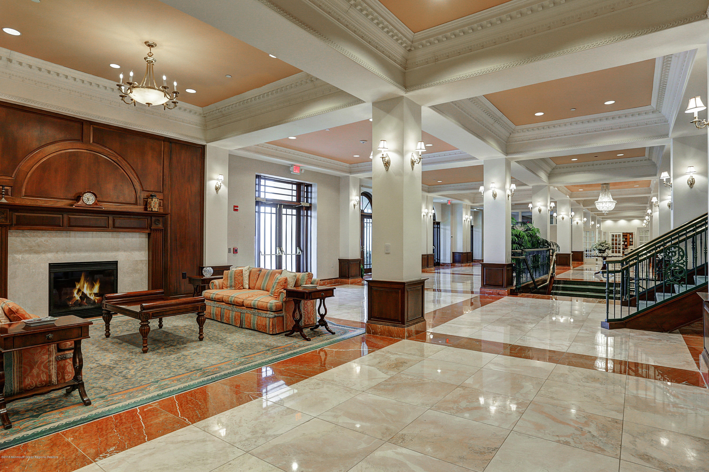 700 Ocean Avenue, Unit 437 Spring Lake, NJ 07762 - Photo 15 of 24 a living room with furniture a large window and a fireplace