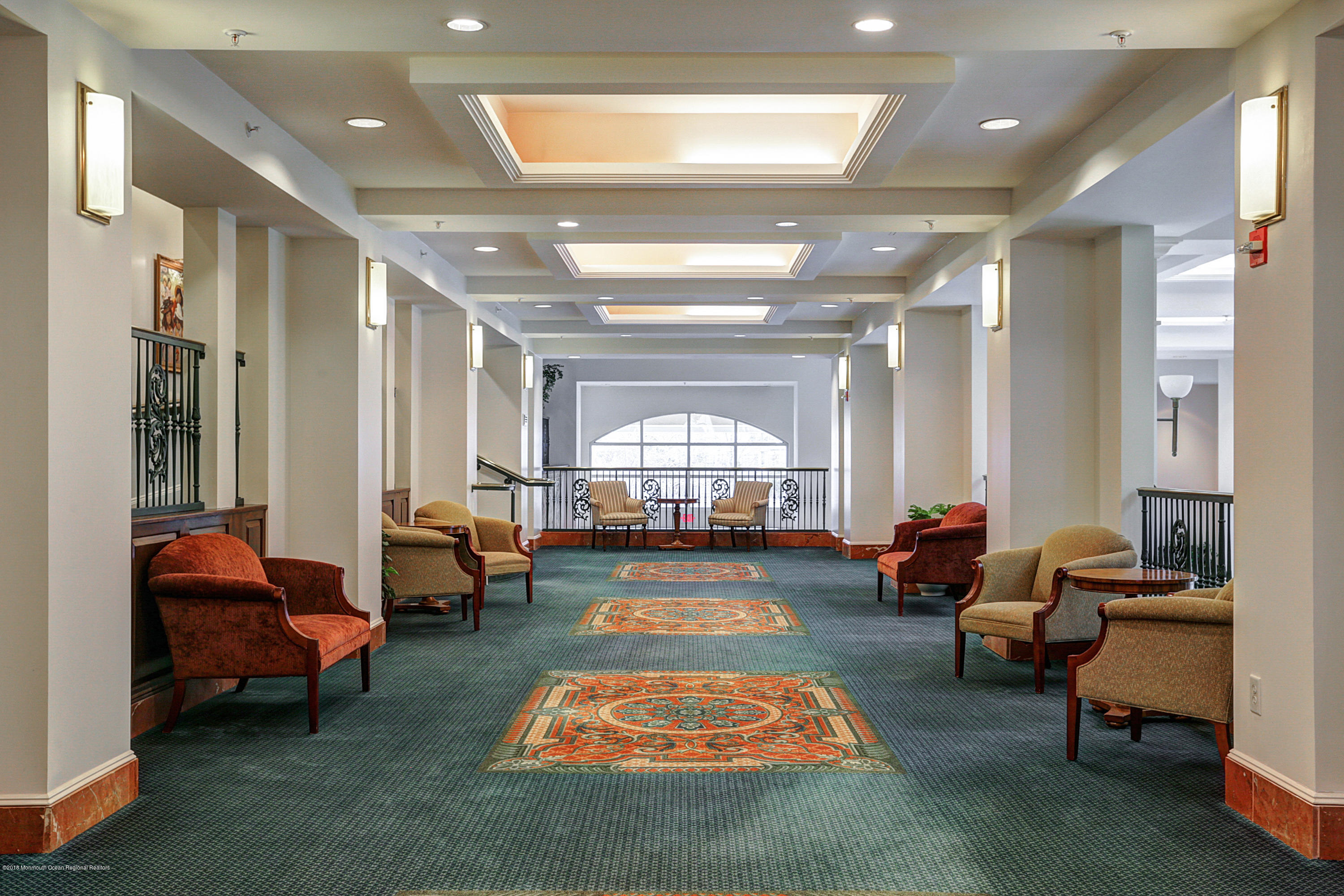 700 Ocean Avenue, Unit 437 Spring Lake, NJ 07762 - Photo 18 of 24 a living room with furniture and a chandelier