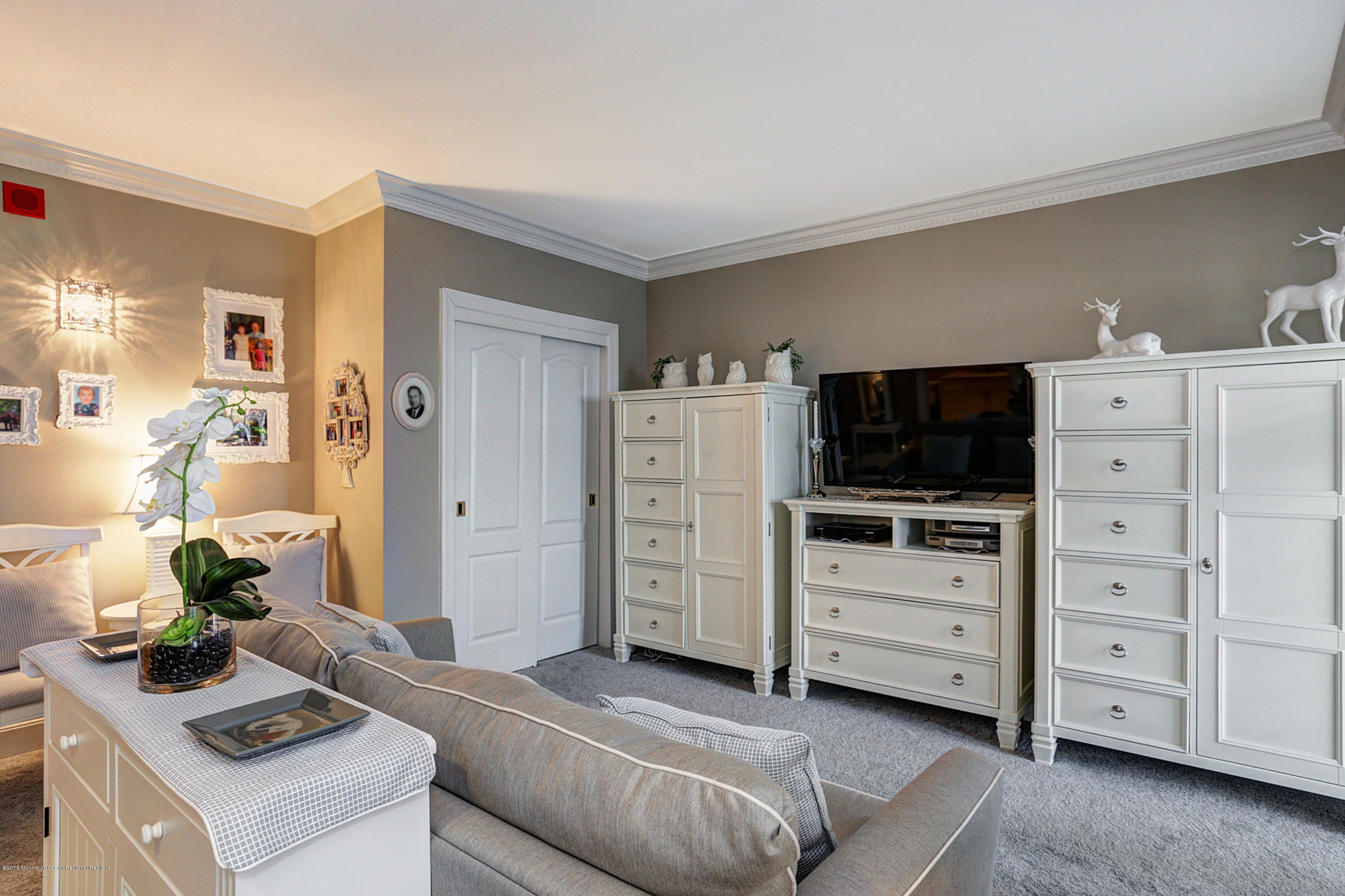 700 Ocean Avenue, Unit 437 Spring Lake, NJ 07762 - Photo 4 of 24 a living room with furniture and flat screen tv