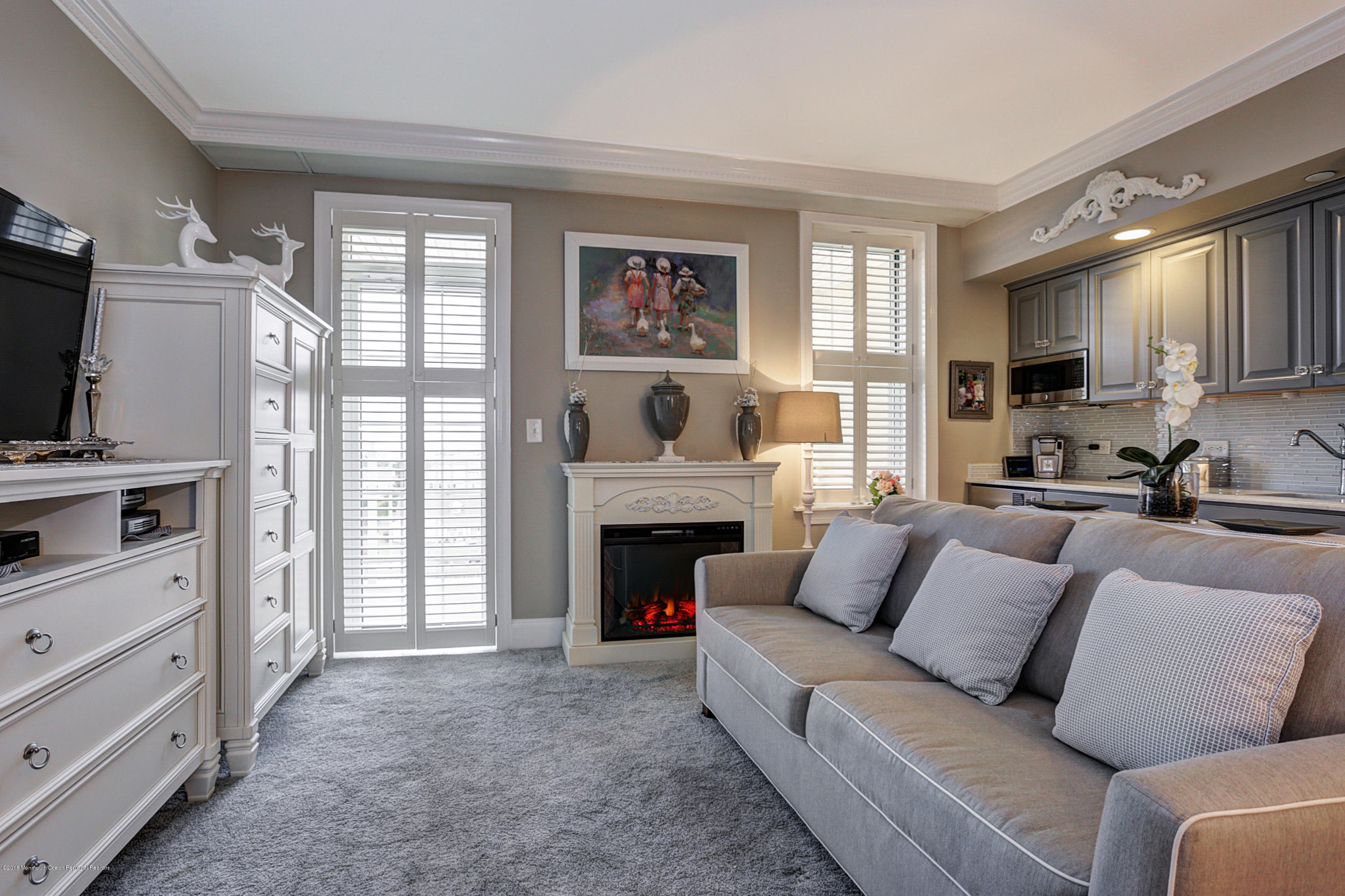 700 Ocean Avenue, Unit 437 Spring Lake, NJ 07762 - Photo 7 of 24 a living room with furniture and a fireplace