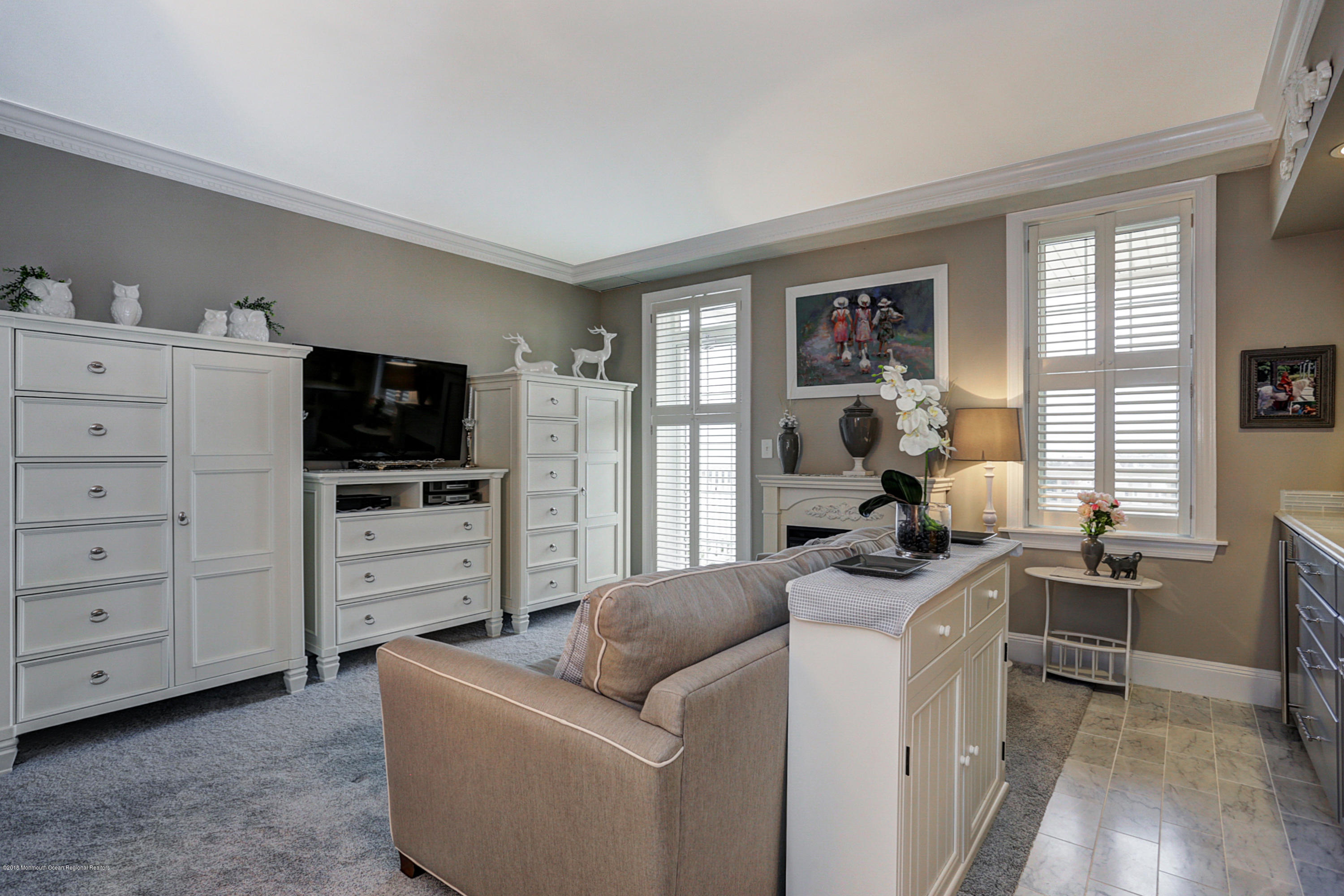 700 Ocean Avenue, Unit 437 Spring Lake, NJ 07762 - Photo 8 of 24 a living room with furniture and a flat screen tv