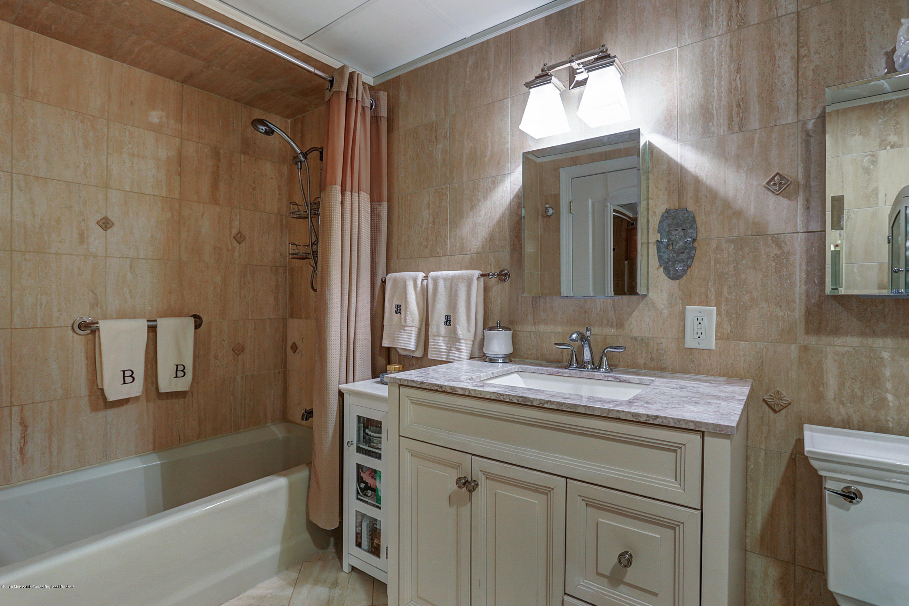 700 Ocean Avenue, Unit 437 Spring Lake, NJ 07762 - Photo 9 of 24 a bathroom with a sink and a mirror
