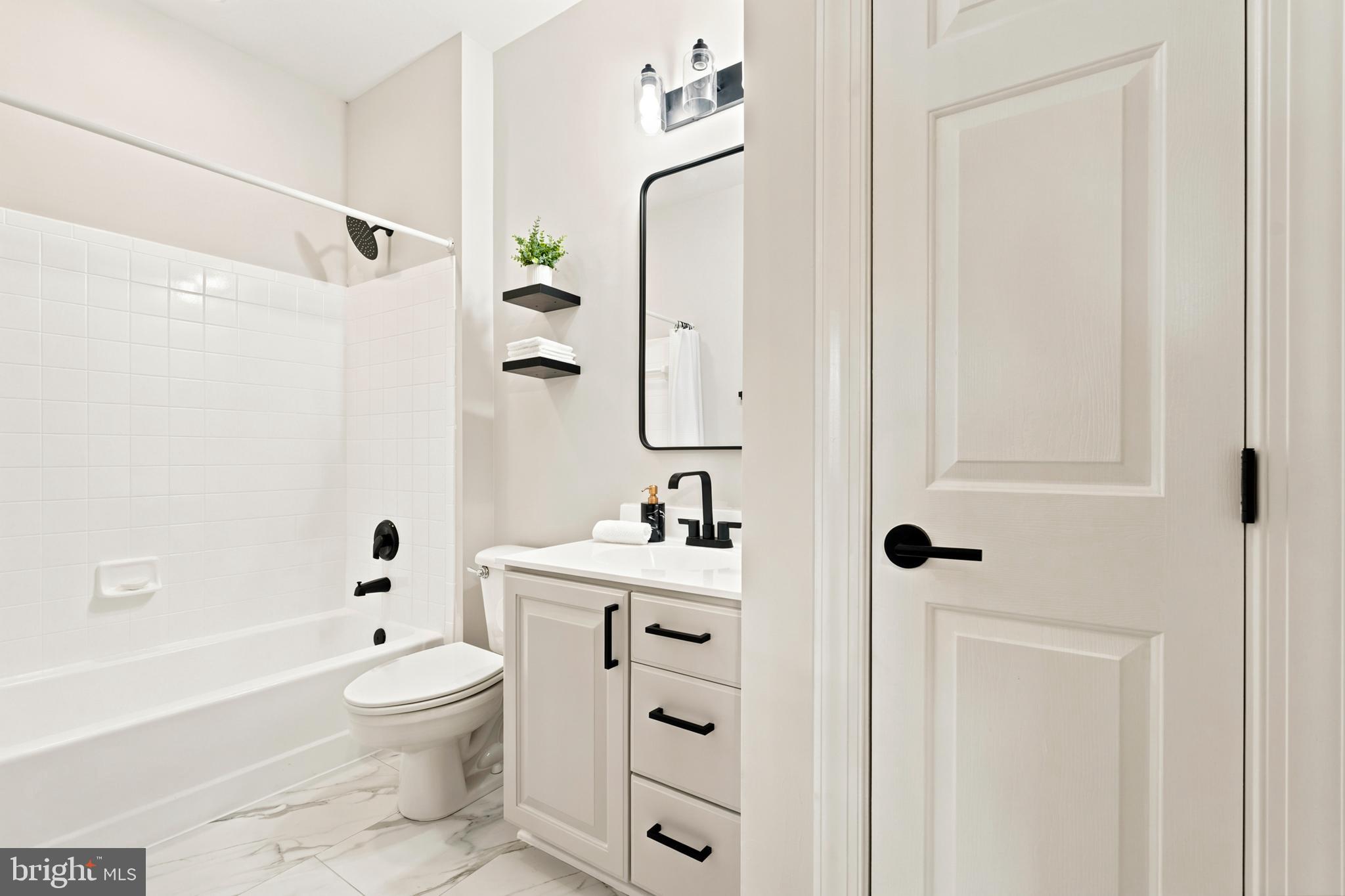 9313 Harrisons Farm Way Laytonsville, MD 20882 - Photo 32 of 77 a bathroom with a sink a toilet and shower