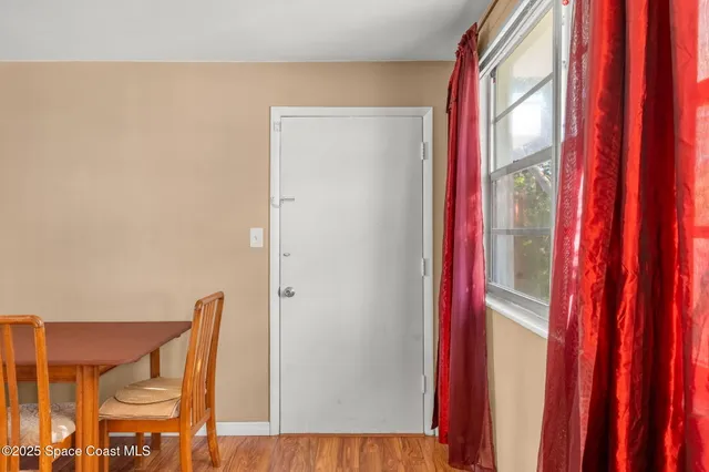 a view of a hallway with two chairs and a large window