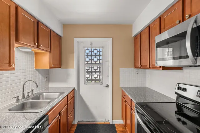 a kitchen with stainless steel appliances granite countertop a sink stove and cabinets