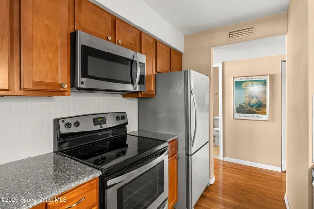 a kitchen with a stove microwave and refrigerator