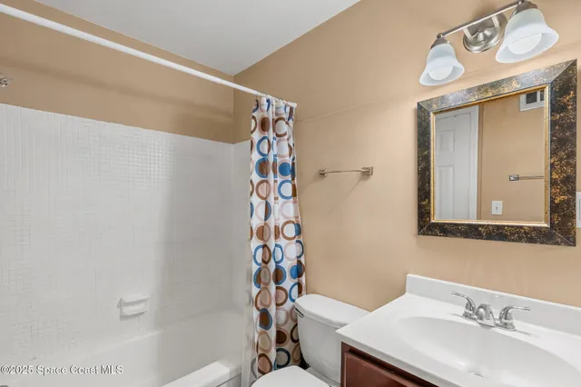a bathroom with a sink a mirror and a shower