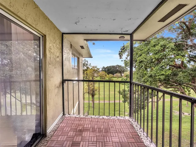 a view of a balcony with wooden floor