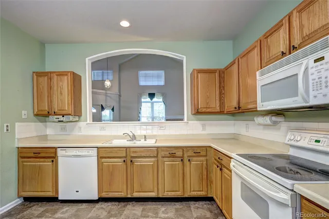 a kitchen with granite countertop a sink and cabinets