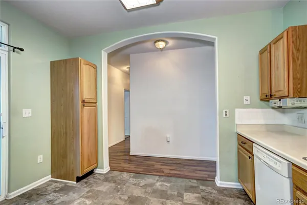 a view of a kitchen with a sink and a refrigerator
