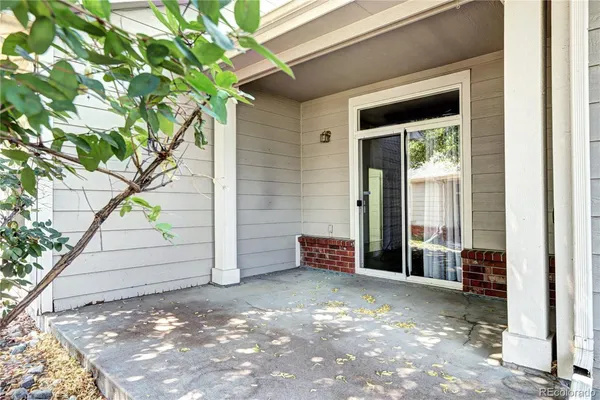 a view of a wooden door and a window