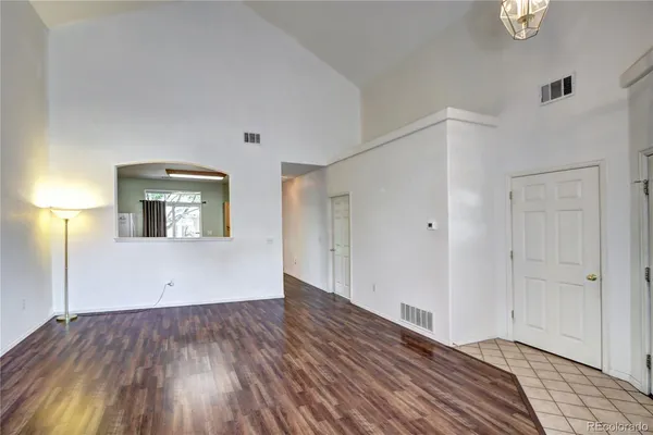 a view of a room with wooden floor and white doors