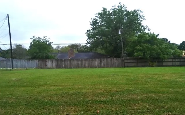 a view of a yard with a fence