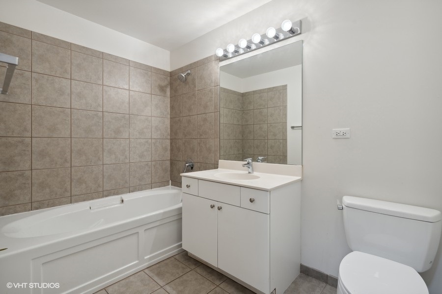 235 West Van Buren Street, Unit 4121 Chicago, IL 60607 - Photo 15 of 25 a bathroom with a sink a toilet and shower
