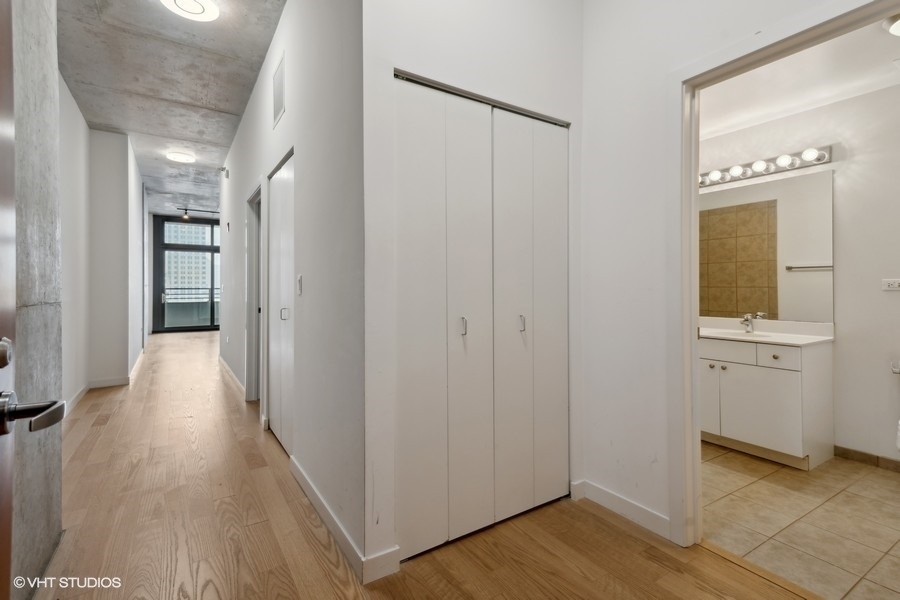 235 West Van Buren Street, Unit 4121 Chicago, IL 60607 - Photo 9 of 25 a view of a hallway with wooden floor and closet area