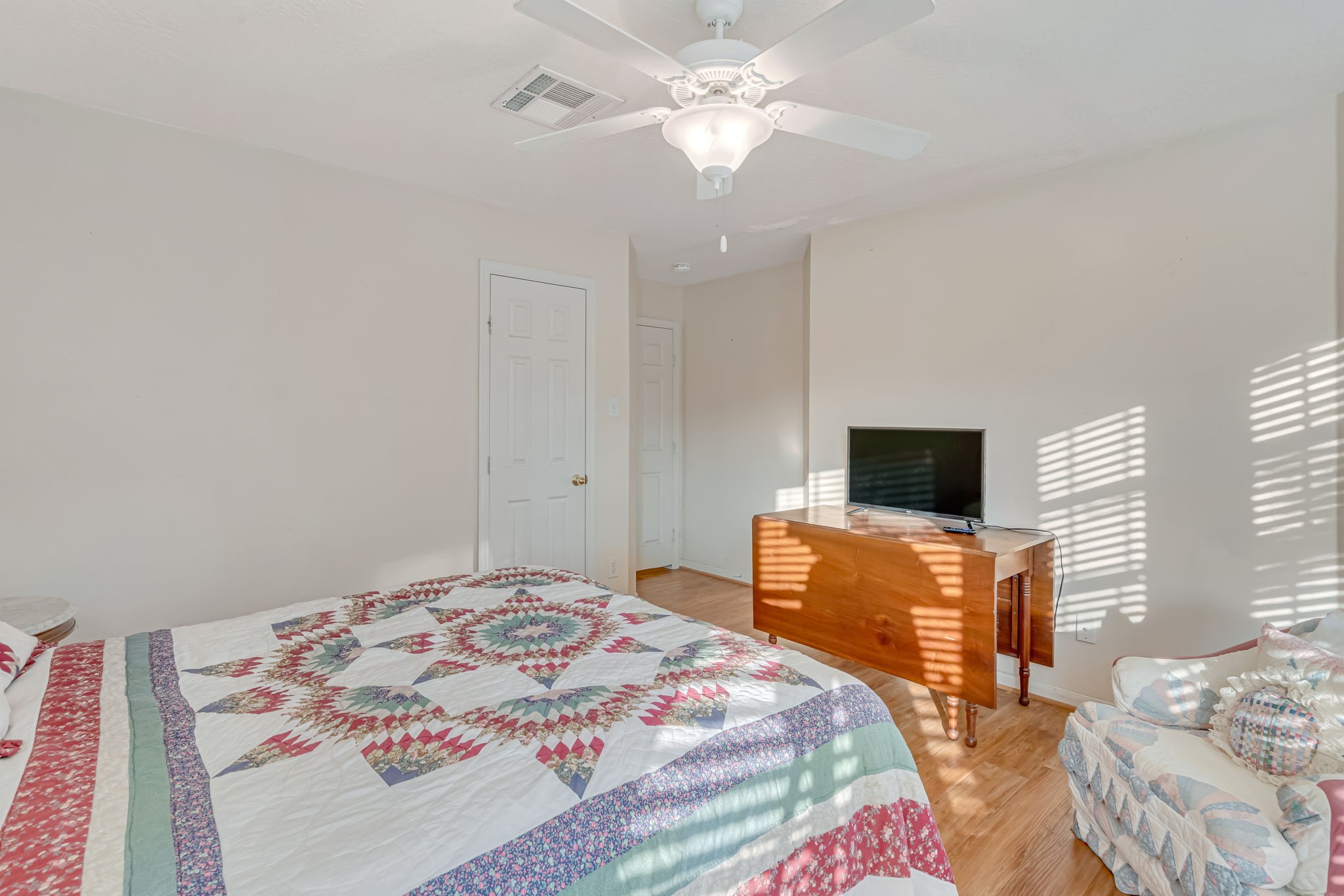 4614 Neches Trail Lane Spring, TX 77388 - Photo 22 of 29 a bedroom with a bed and a flat screen tv