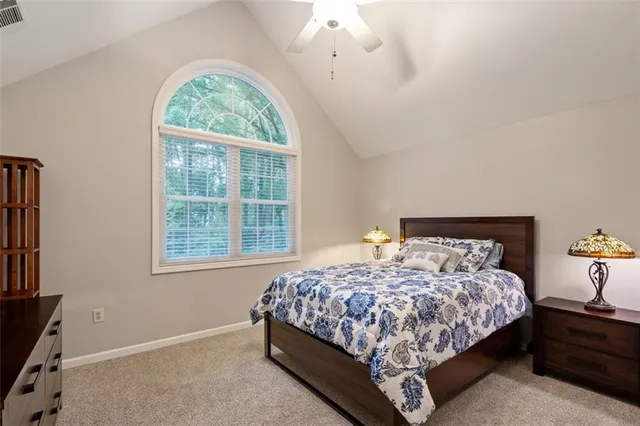 a bedroom with a large bed and a window