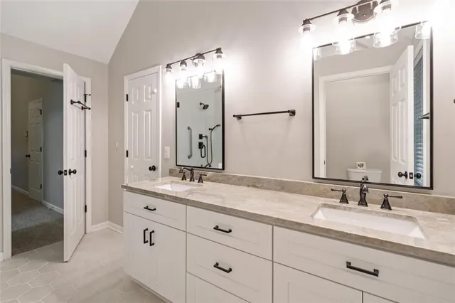 a bathroom with a double vanity sink mirror and double