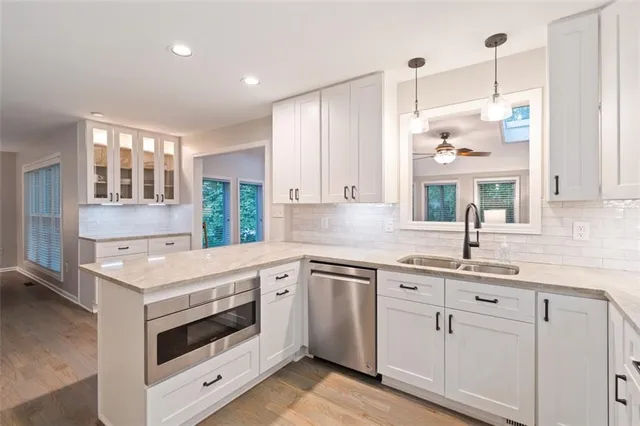 a kitchen with white cabinets and white appliances