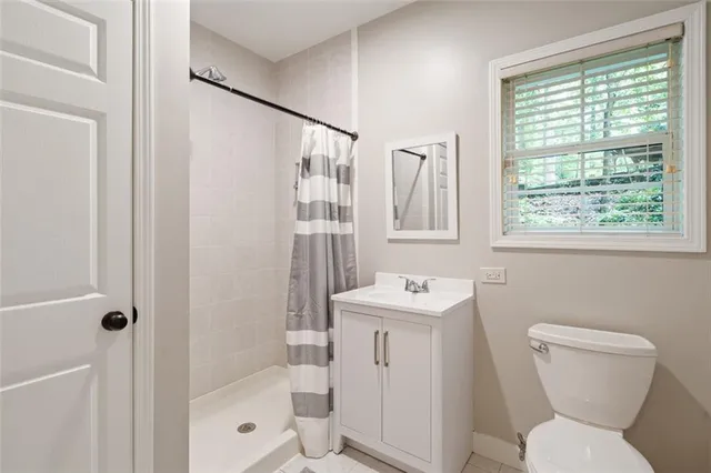 a bathroom with a toilet sink and shower
