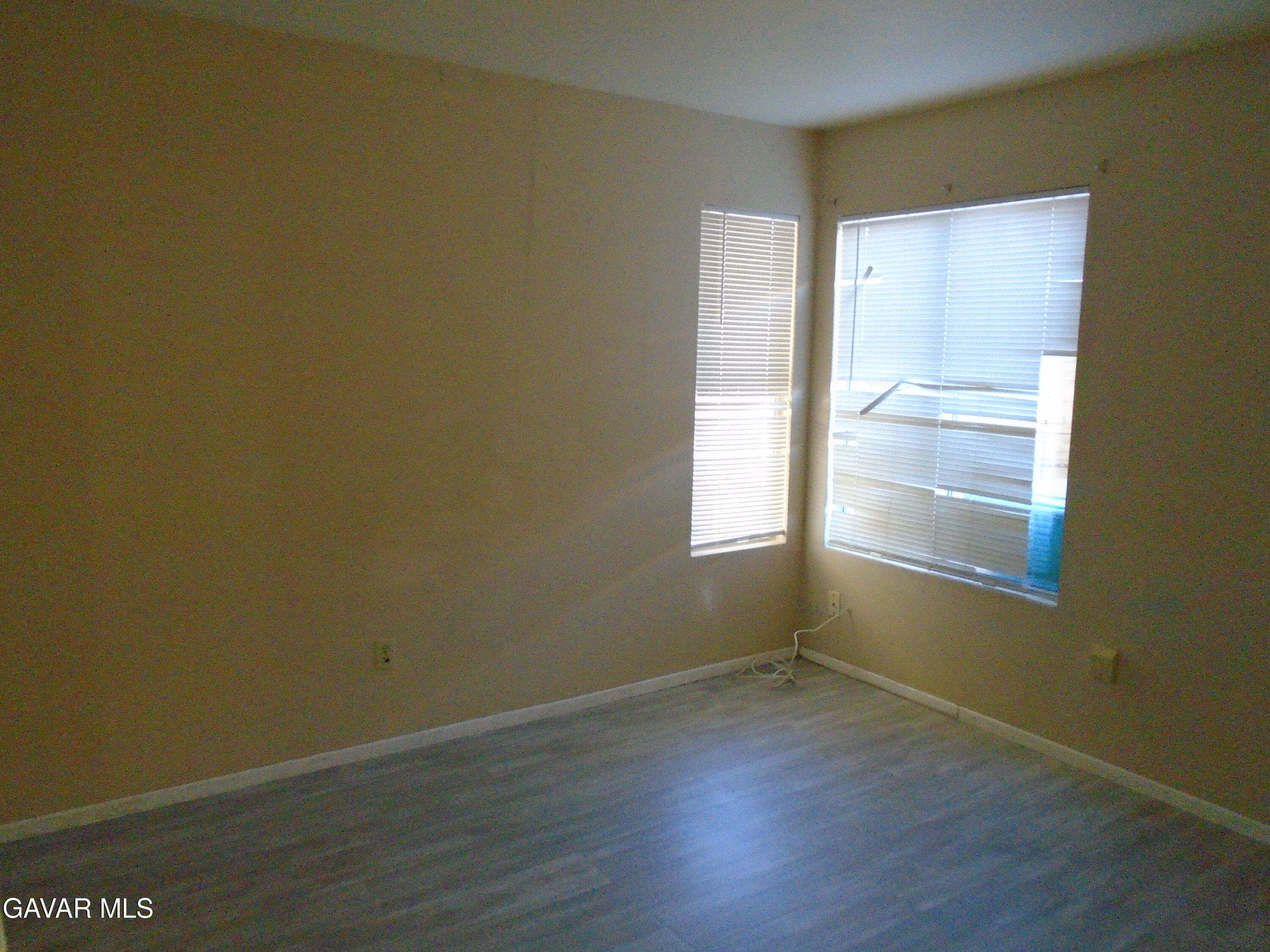 37739 Cardiff Street Palmdale, CA 93550 - Photo 14 of 32 an empty room with wooden floor and windows