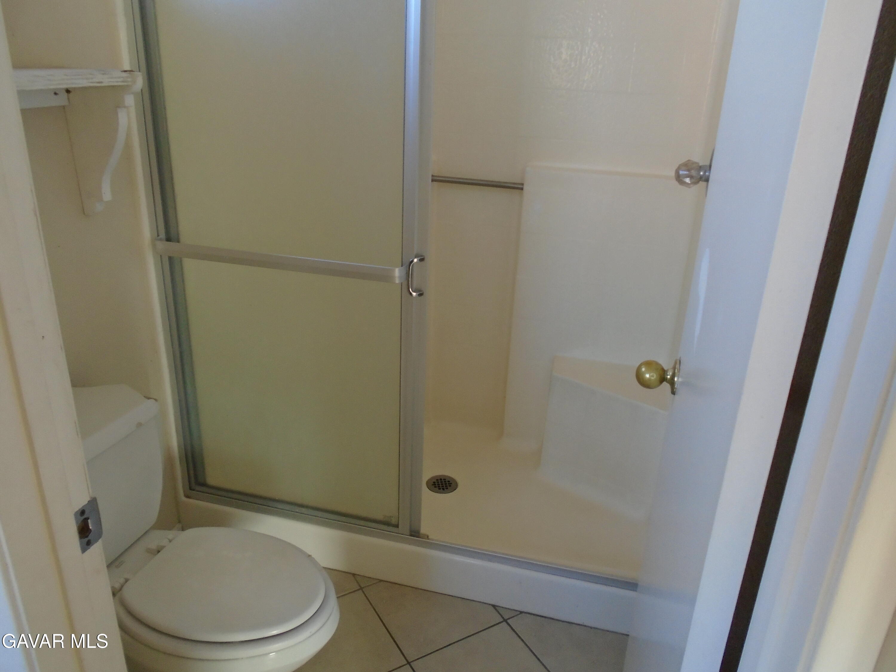 37739 Cardiff Street Palmdale, CA 93550 - Photo 26 of 32 a bathroom with a toilet and a shower