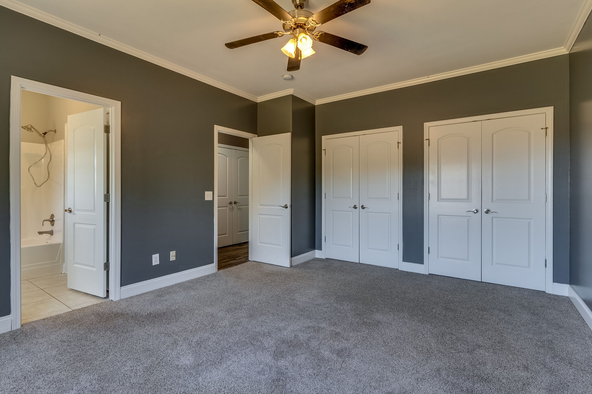 389 Coker Ford Road Portland, TN 37148 - Photo 8 of 15 an empty room with closet and a chandelier fan
