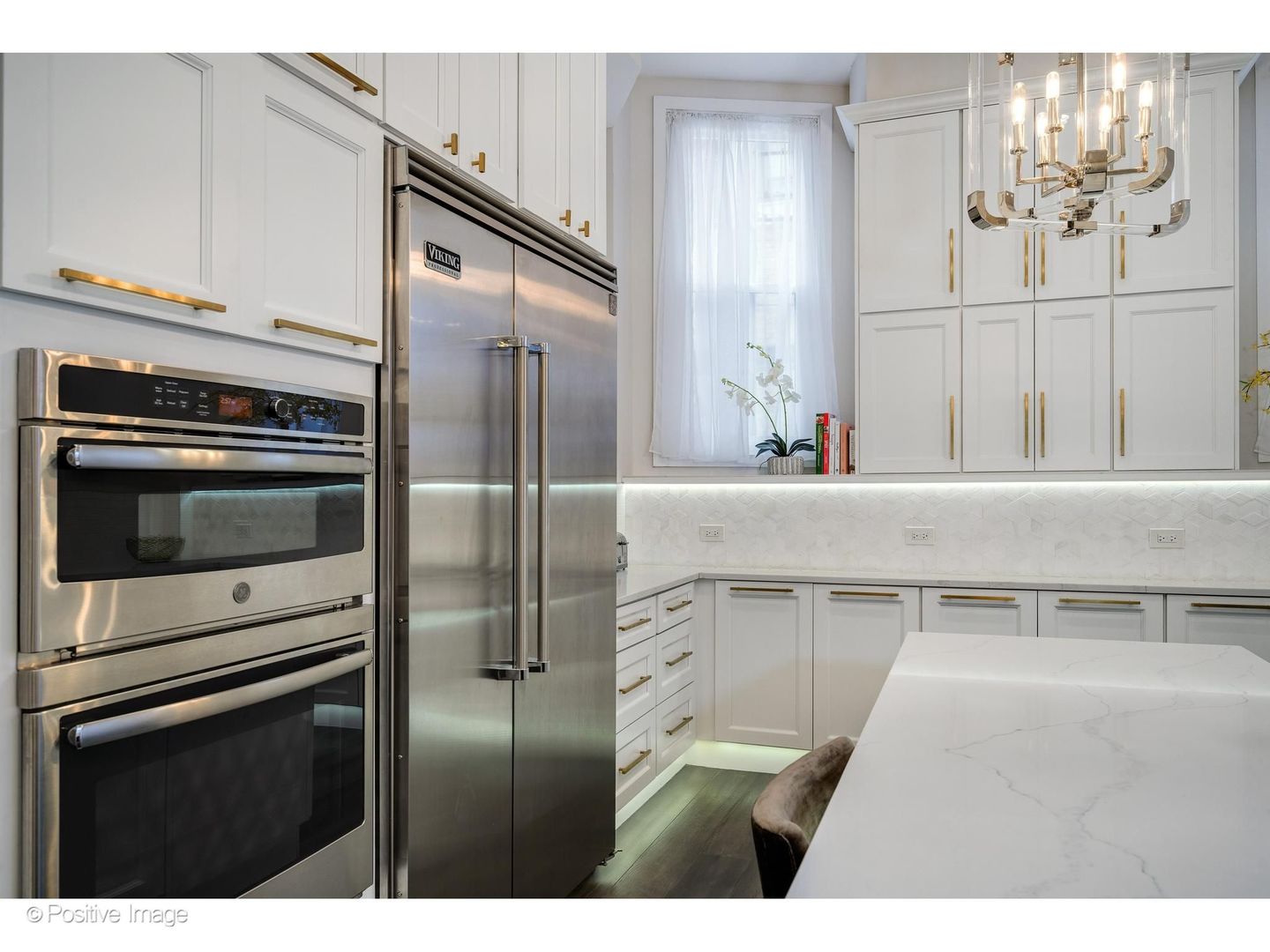 32 East Bellevue Place Chicago, IL 60611 - Photo 19 of 52 a kitchen with a refrigerator and cabinets