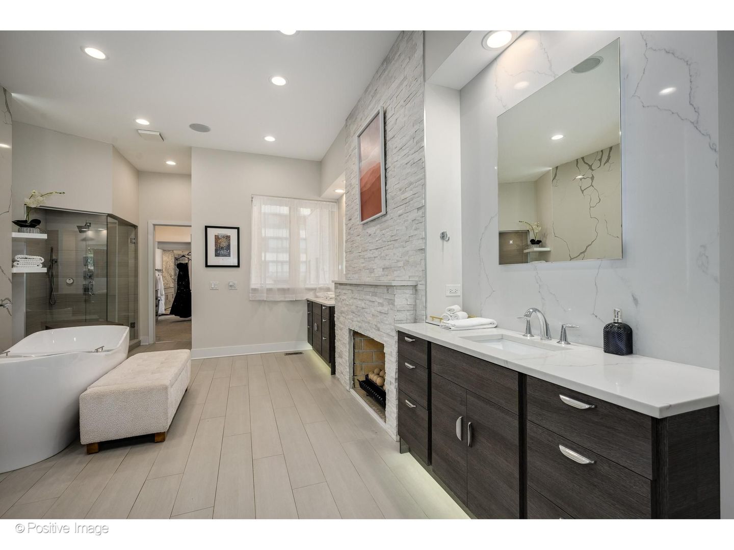 32 East Bellevue Place Chicago, IL 60611 - Photo 25 of 52 a large bathroom with a double vanity sink a large mirror and a bathtub
