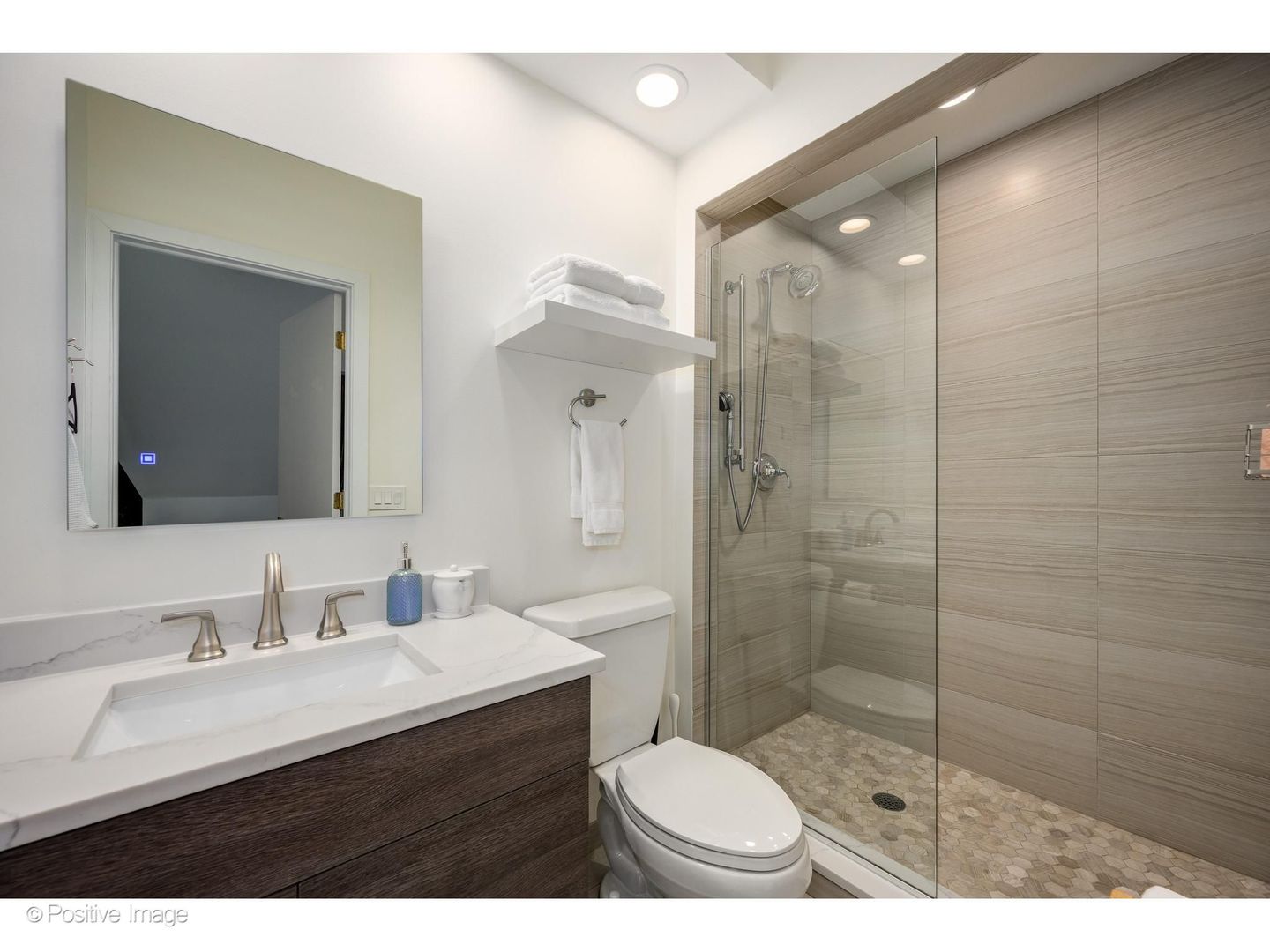 32 East Bellevue Place Chicago, IL 60611 - Photo 42 of 52 a bathroom with a sink toilet a mirror and shower