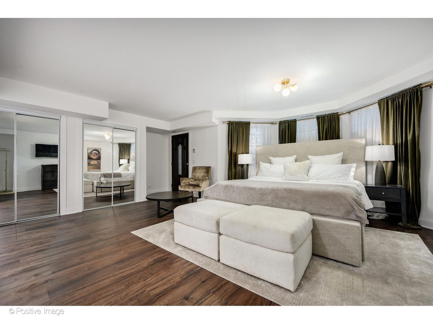 32 East Bellevue Place Chicago, IL 60611 - Photo 43 of 52 a spacious bedroom with a bed a mirror and wooden floor