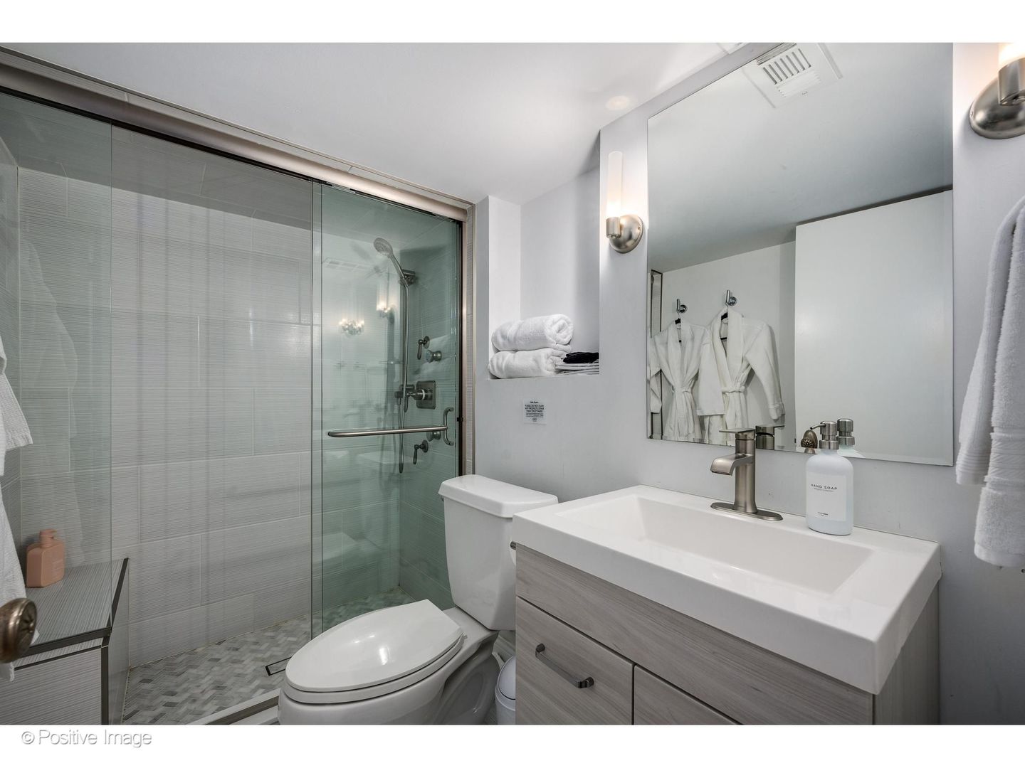 32 East Bellevue Place Chicago, IL 60611 - Photo 45 of 52 a bathroom with a sink toilet a mirror and shower