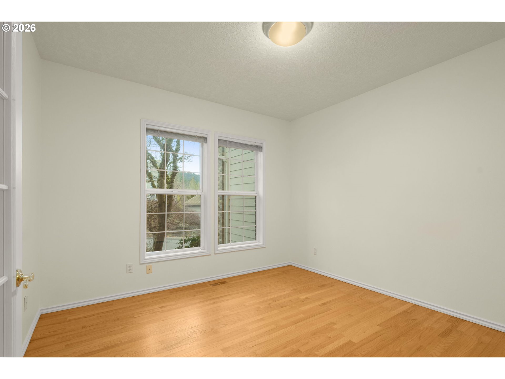 1323 Northwest Mayfield Road Portland, OR 97229 - Photo 12 of 32 a view of empty room with wooden floor