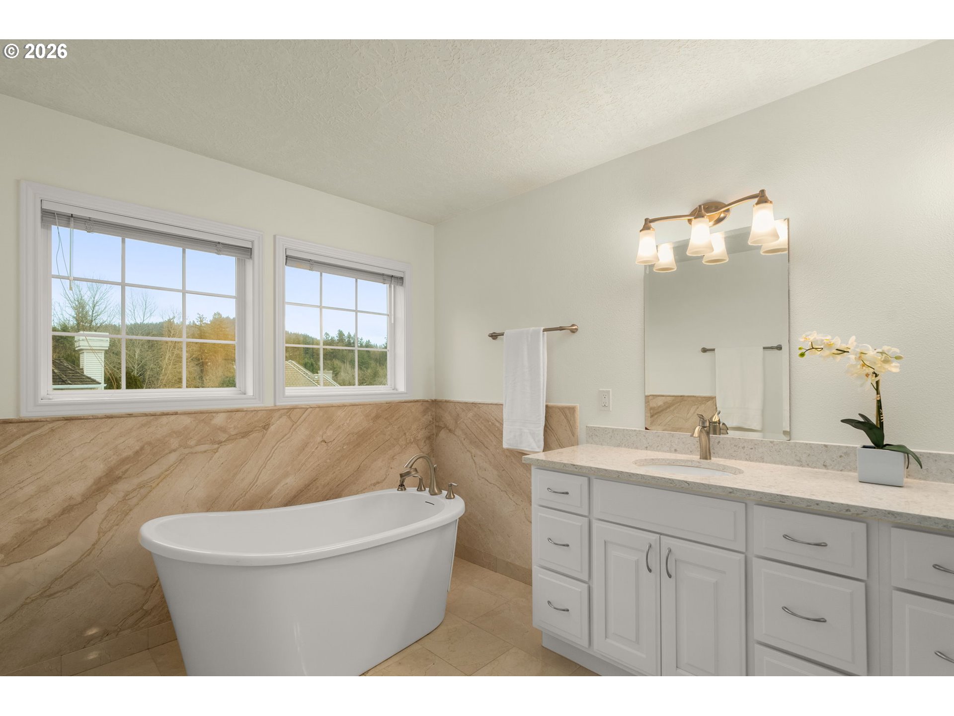 1323 Northwest Mayfield Road Portland, OR 97229 - Photo 21 of 32 a bathroom with a granite countertop sink a large mirror a bathtub and window