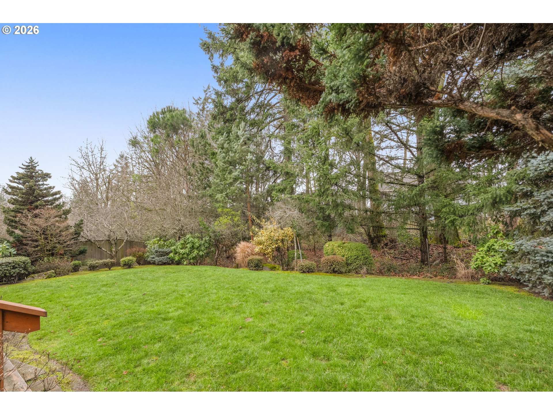 1323 Northwest Mayfield Road Portland, OR 97229 - Photo 30 of 32 a backyard of a house with lots of green space
