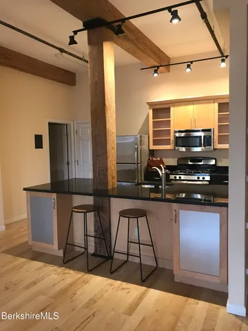 a view of a living room with furniture and a flat screen tv