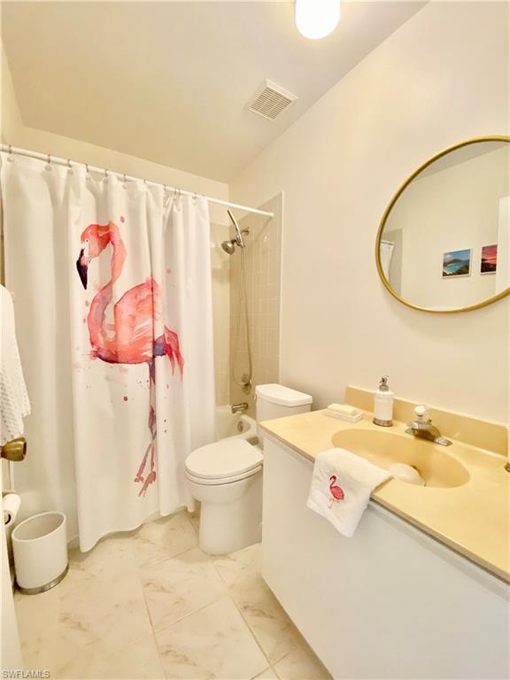 5735 Whitaker Road, Unit B201 Naples, FL 34112 - Photo 13 of 26 a bathroom with a sink toilet and shower