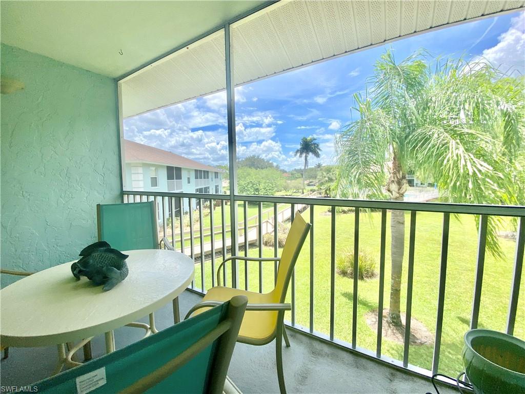 5735 Whitaker Road, Unit B201 Naples, FL 34112 - Photo 15 of 26 a view of a dining room with furniture window and outside view