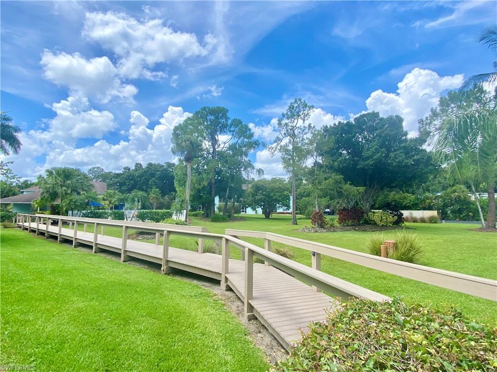 5735 Whitaker Road, Unit B201 Naples, FL 34112 - Photo 17 of 26 a view of a park with large trees
