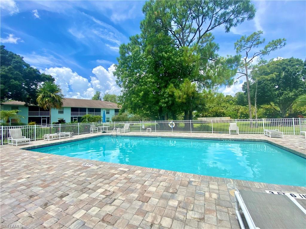 5735 Whitaker Road, Unit B201 Naples, FL 34112 - Photo 20 of 26 a view of a house with a yard