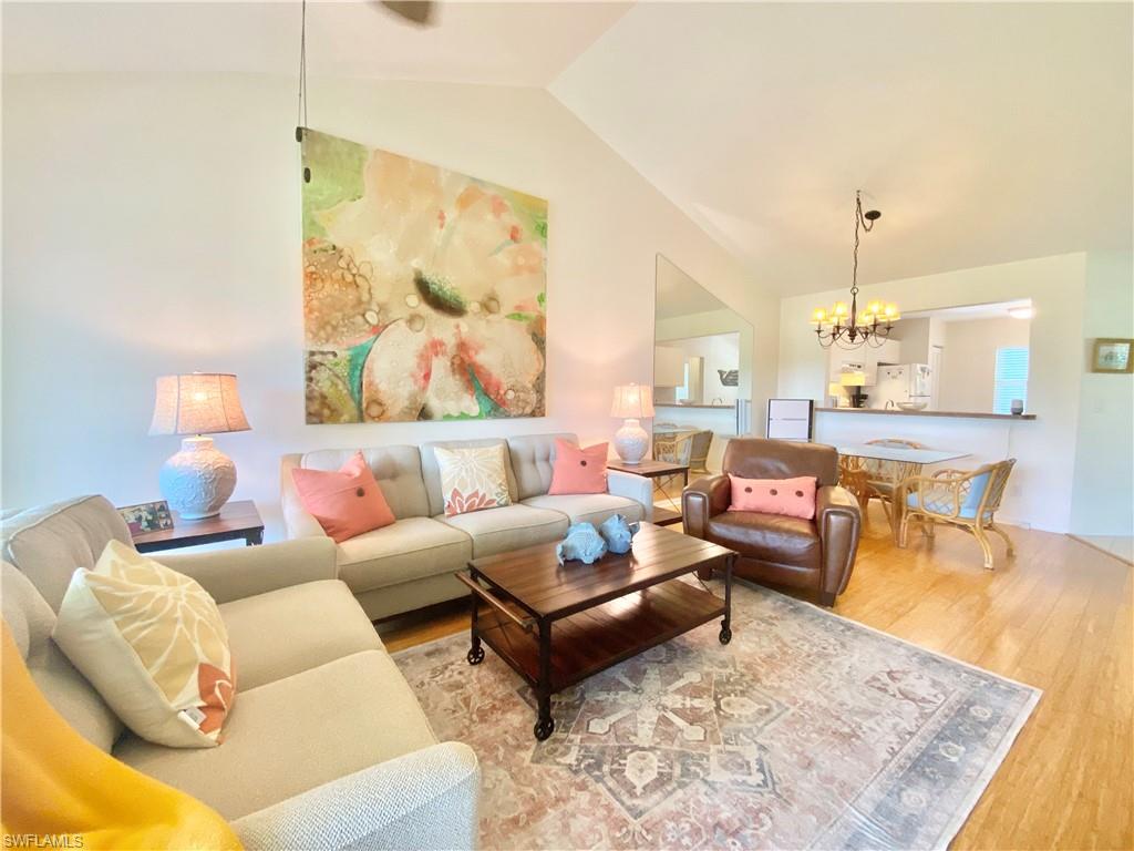 5735 Whitaker Road, Unit B201 Naples, FL 34112 - Photo 2 of 26 a living room with furniture and a table
