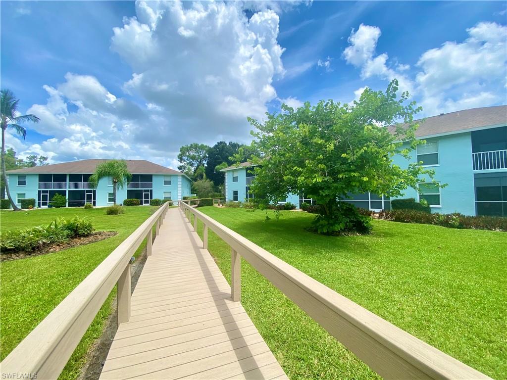 5735 Whitaker Road, Unit B201 Naples, FL 34112 - Photo 21 of 26 a view of a house with a yard