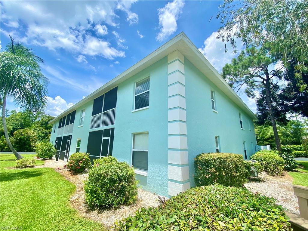 5735 Whitaker Road, Unit B201 Naples, FL 34112 - Photo 24 of 26 a view of a house with a yard