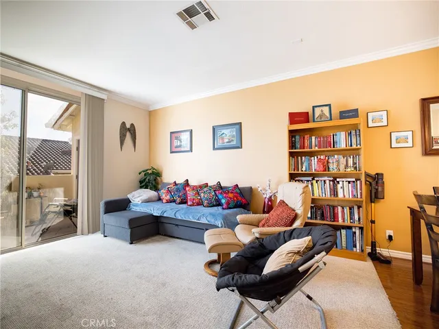 a living room with furniture and a book shelf
